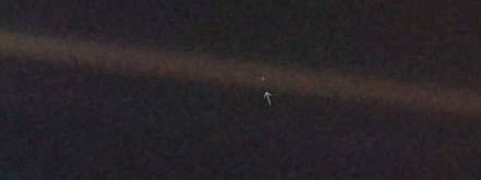 The earth a pale blue dot suspended in a sunbeam.jpg